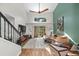Bright living room boasts high ceilings, a fan, large windows, and stylish décor at 17557 Fairmeadow Dr, Tampa, FL 33647