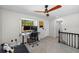 Loft space featuring a workstation with two monitors and a ceiling fan, creating an ideal home office at 17557 Fairmeadow Dr, Tampa, FL 33647