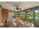 Relaxing screened patio with seating, a ceiling fan, and peaceful water views, perfect for outdoor enjoyment at 17557 Fairmeadow Dr, Tampa, FL 33647
