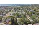 An aerial view of the home nestled in a tree-filled neighborhood by the ocean at 1775 Michigan Ne Ave, St Petersburg, FL 33703