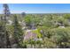 Scenic aerial view of a neighborhood home with mature trees and a glimpse of the ocean at 1775 Michigan Ne Ave, St Petersburg, FL 33703