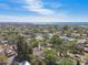 An aerial view shows the neighborhood with manicured lawns, mature trees, and a glimpse of the ocean horizon at 1775 Michigan Ne Ave, St Petersburg, FL 33703