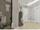 Finished basement featuring a utility area with water heater, air conditioner, and wood tile flooring at 1775 Michigan Ne Ave, St Petersburg, FL 33703