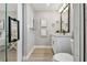 Bathroom with white vanity, framed mirror, and glass enclosed shower at 1775 Michigan Ne Ave, St Petersburg, FL 33703