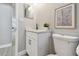 Well-lit bathroom featuring a white vanity with marble countertop and black hardware with a decorative print on the wall at 1775 Michigan Ne Ave, St Petersburg, FL 33703