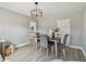 Dining room featuring stylish light fixture, gray walls, wood-look tile flooring, and seating for four guests at 1775 Michigan Ne Ave, St Petersburg, FL 33703