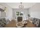 Dining room featuring stylish light fixture, gray walls, wood-look tile flooring, and seating for five guests at 1775 Michigan Ne Ave, St Petersburg, FL 33703