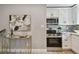 Well-lit kitchen area showcasing stainless steel appliances, white cabinetry, and stylish backsplash at 1775 Michigan Ne Ave, St Petersburg, FL 33703