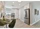 Well-lit kitchen featuring stainless steel appliances, white cabinetry, and stylish backsplash at 1775 Michigan Ne Ave, St Petersburg, FL 33703