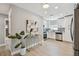 Bright kitchen with stainless steel appliances, modern white cabinets, and wood tile flooring at 1775 Michigan Ne Ave, St Petersburg, FL 33703