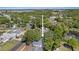 Aerial view showing property, lush surroundings, nearby roads, pond, and community features at 1849 Diane Dr, Clearwater, FL 33759