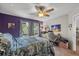 Dual color bedroom with modern decor, ceiling fan, and workspace area at 1849 Diane Dr, Clearwater, FL 33759