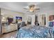 Comfortable bedroom features dresser, a ceiling fan, and multiple entryways at 1849 Diane Dr, Clearwater, FL 33759