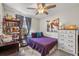 Cozy bedroom with ceiling fan, bookshelves, and a comfortable bed at 1849 Diane Dr, Clearwater, FL 33759