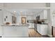 Well-lit modern kitchen with stainless steel appliances, granite countertops, and stylish white cabinets at 1849 Diane Dr, Clearwater, FL 33759