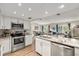 Well-equipped kitchen with stainless steel appliances, granite counters, and an open view to the living area at 1849 Diane Dr, Clearwater, FL 33759