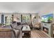 Bright living room featuring a comfortable sofa, large windows, and stylish decor at 1849 Diane Dr, Clearwater, FL 33759