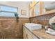 The bathroom features a vessel sink with a stone countertop and decorative tile backsplash at 2214 Wilshire Dr, Dunedin, FL 34698