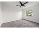 Bedroom featuring neutral paint, trim, carpet, and a single window at 2214 Wilshire Dr, Dunedin, FL 34698