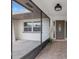 Inviting screened entryway leading to a front door with decorative glass and tiled floor at 2214 Wilshire Dr, Dunedin, FL 34698