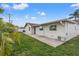 The exterior of this house features a well-manicured lawn and an A/C unit at 2214 Wilshire Dr, Dunedin, FL 34698