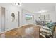 Open-concept foyer leading to a dining area, featuring abundant natural light and durable tile flooring at 2214 Wilshire Dr, Dunedin, FL 34698