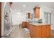 A modern kitchen with stainless steel appliances, granite countertops, and wood cabinetry at 2214 Wilshire Dr, Dunedin, FL 34698