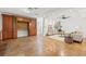 Spacious living room with wood floors, custom built-ins, and modern decor and lighting at 2214 Wilshire Dr, Dunedin, FL 34698