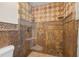 The glass-enclosed shower has decorative diamond pattern tiles with a mosaic accent border at 2214 Wilshire Dr, Dunedin, FL 34698