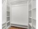 The spacious walk-in closet has built-in shelving and a hanging rod for optimal storage capacity at 2214 Wilshire Dr, Dunedin, FL 34698