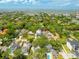 An aerial view showcases a lush, tree-filled neighborhood close to the water, promoting a serene lifestyle at 2304 S Occident St, Tampa, FL 33629