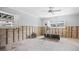 Bedroom featuring windows, ceiling fan, and telescope, awaiting renovation at 2304 S Occident St, Tampa, FL 33629