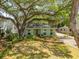 Charming single-story home with a mature shade tree, inviting front yard, and lovely landscaping at 2304 S Occident St, Tampa, FL 33629