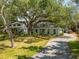 Charming home featuring a beautiful lawn, mature trees and lush landscaping at 2304 S Occident St, Tampa, FL 33629