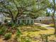 Charming home featuring a beautiful lawn, mature trees and lush landscaping at 2304 S Occident St, Tampa, FL 33629