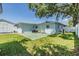 A backyard with a concrete patio, shed, part of the home's exterior and a fenced yard at 2808 W Lake Ave, Tampa, FL 33607