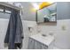 Small bathroom features white tile, a vintage style vanity and mirror and a hanging towel at 2808 W Lake Ave, Tampa, FL 33607