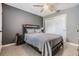 Bedroom with gray walls, a queen bed, a ceiling fan and light neutral carpet at 2808 W Lake Ave, Tampa, FL 33607