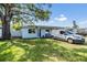 Charming single-story home features a well-maintained lawn and mature shade trees at 2808 W Lake Ave, Tampa, FL 33607