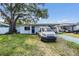 Cozy single-story home with a covered parking area and a welcoming front lawn at 2808 W Lake Ave, Tampa, FL 33607