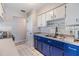 Bright kitchen featuring white and blue cabinetry with gold hardware and stainless steel appliances at 2808 W Lake Ave, Tampa, FL 33607