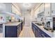 Well-lit kitchen featuring modern blue cabinetry and stainless steel appliances at 2808 W Lake Ave, Tampa, FL 33607