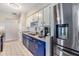 Bright kitchen featuring blue and white cabinetry with stainless steel appliances at 2808 W Lake Ave, Tampa, FL 33607