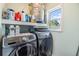 Modern laundry room with front-loading washer and dryer at 2808 W Lake Ave, Tampa, FL 33607