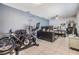 A spacious bonus room with a home office and exercise equipment at 2808 W Lake Ave, Tampa, FL 33607