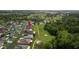 Aerial view of home in established community and overlooking golf course with mature trees at 29408 Princeville Dr, San Antonio, FL 33576