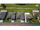 Overhead view showcases well-maintained homes in a neighborhood adjacent to a golf course at 29408 Princeville Dr, San Antonio, FL 33576
