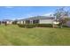 Expansive backyard with green lawn and trimmed hedges, perfect for outdoor activities and relaxation at 29408 Princeville Dr, San Antonio, FL 33576