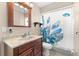 Bathroom with a marble vanity and shower with a patterned curtain at 29408 Princeville Dr, San Antonio, FL 33576