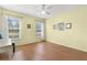 Neutral bedroom with laminate floors and two windows with views to the exterior at 29408 Princeville Dr, San Antonio, FL 33576